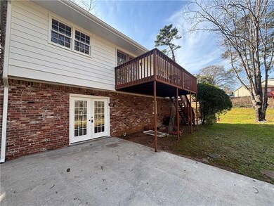 Rear view of property with stairway, a wooden deck