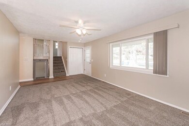 Unfurnished living room featuring dark colored car