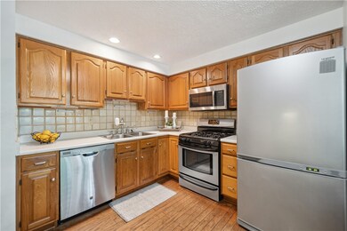 Kitchen is equipped with stainless appliances.