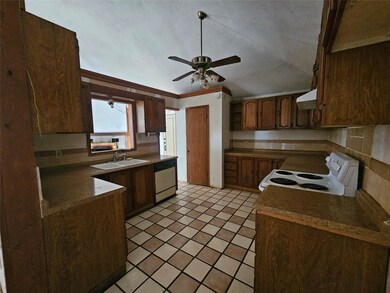 Kitchen featuring white electric range, exhaust h