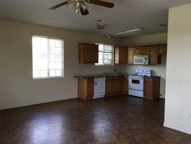Kitchen with dark floors, visible vents, a sink, 