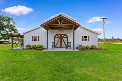 View of pole building featuring a lawn