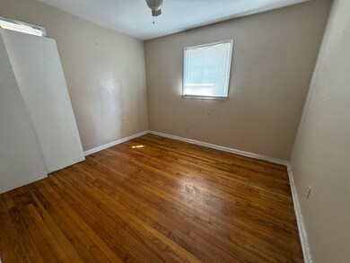 Unfurnished room featuring ceiling fan and hardwoo