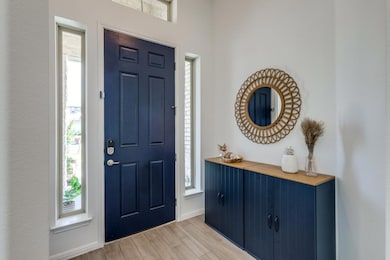 Entrance foyer with light wood finished floors an