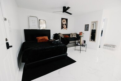 Bedroom featuring marble finish floors and a ceiling fan