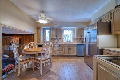 Updated kitchen features a wine frig, trash drawer
