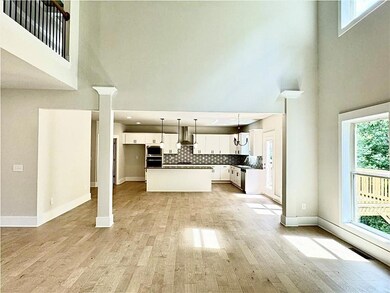 Kitchen with decorative backsplash, light wood fin