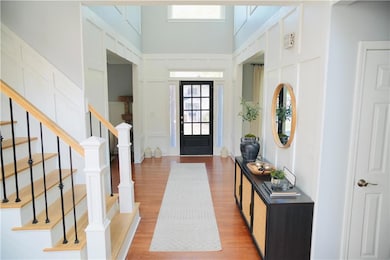 Entrance foyer featuring stairway, wood finished f