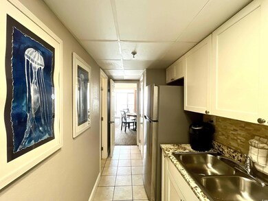 Kitchen featuring backsplash, white cabinetry, sin