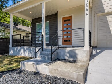 Property entrance with a garage and covered porch