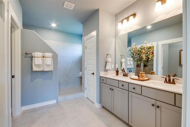 Master bathroom has tiled flooring, tall double bowl vanities, quartz countertops and Moen faucets