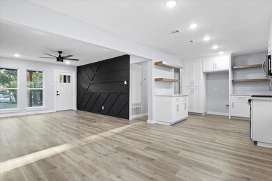 Kitchen featuring visible vents, open shelves, whi