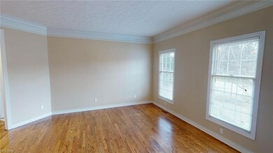Formal living room with updated wood flooring.