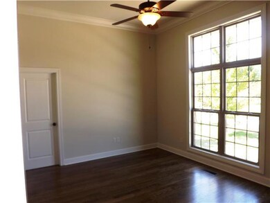This bedroom/study has bright transom windows, ceiling fan, hardwood floors and access to a full bath. It also has a walk-in closet.