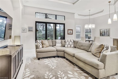 Living room with light tile patterned floors, a tr
