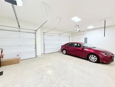 Garage featuring electric panel and a garage door