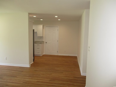 Hallway with recessed lighting and light wood-type flooring