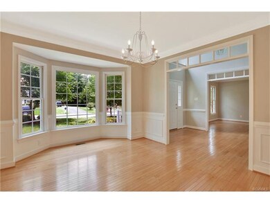 Formal dining room with wood floor, transom window