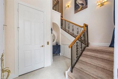 Entrance to unit with private elevator and carpeted stairs to living area