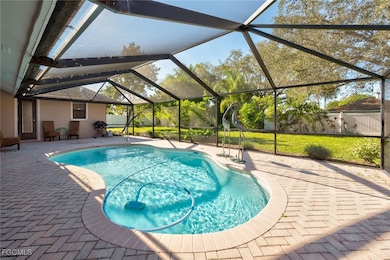 Outdoor pool with a patio area and glass enclosure