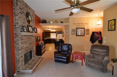 Living room has a decorative plant or display shel
