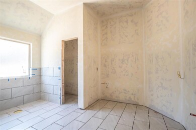 Tiled spare room with lofted ceiling