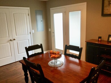 Large eat-in area in kitchen.  Doors lead to laundry closet with lots of shelves.  
