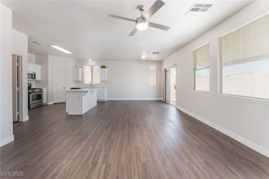 Unfurnished living room with a ceiling fan, basebo