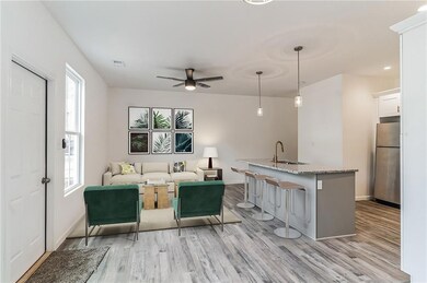 Unfurnished living room featuring ceiling fan, lig