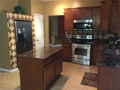 Kitchen with tasteful backsplash, a center island,