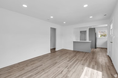 Unfurnished living room with light wood-style flooring and recessed lighting