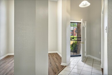 Foyer featuring light wood-type flooring and a hig