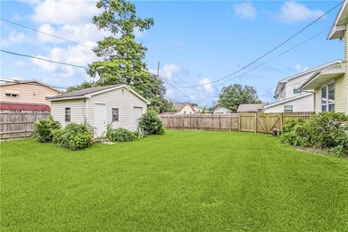 Spacious backyard with DBL gates used for rear yard access. Detached building is on a slab, built around 30 - 35 years ago. The left side was used as an office with a window unit & electricity (window unit most likely does not work, Seller is not rep