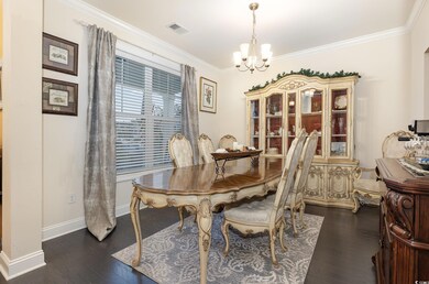 Dining space featuring crown molding, a notable ch