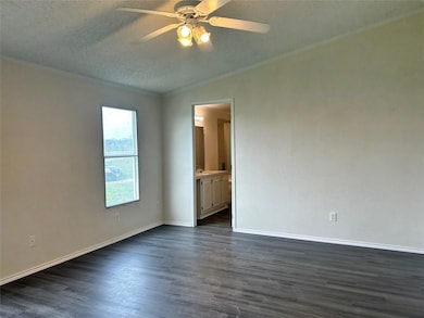 Spare room with dark wood-style floors, crown mol