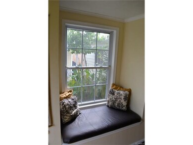 window seat in foyer has storage
