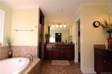 The stylish Master Bath features a garden tub, sep