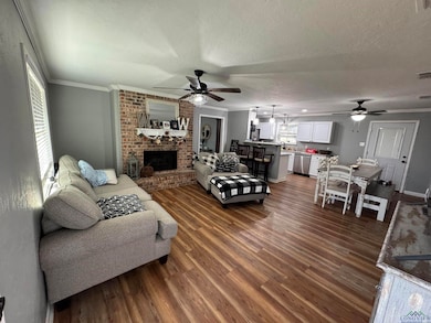 Living room with a brick fireplace, ornamental mol