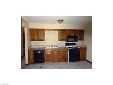 Kitchen with ceramic tile flooring and a few appli