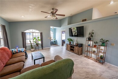 Living room featuring ceiling fan and lofted ceili