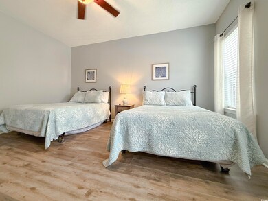 Bedroom with a ceiling fan and wood finished floor