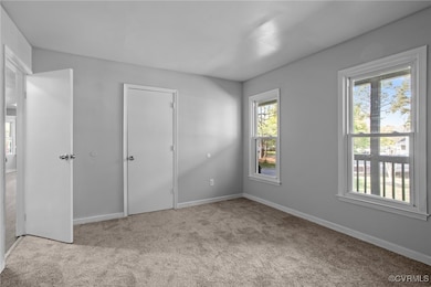 Unfurnished bedroom featuring carpet, baseboards,