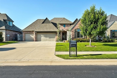 French country inspired facade featuring an attached garage, brick siding, concrete driveway, and a front lawn
