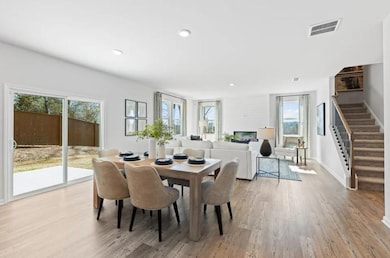 Dining area with stairway, light wood-style floors, recessed lighting, and baseboards