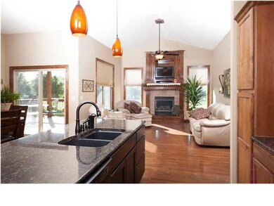 View from the kitchen into the cozy hearth room wi