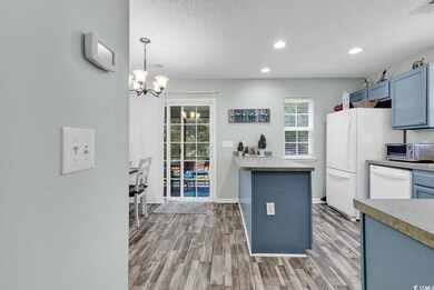 Kitchen with kitchen peninsula, decorative light f