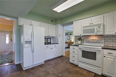 Kitchen has ceramic tiled floors, subway tile, and