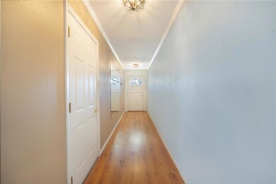 Hall with crown molding and hardwood / wood-style 