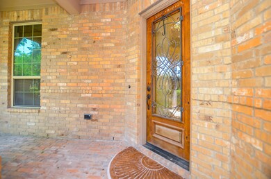 Covered Brick Front Porch with Beautiful Glass wit