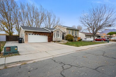 View of front of house featuring concrete driveway and an attached garage